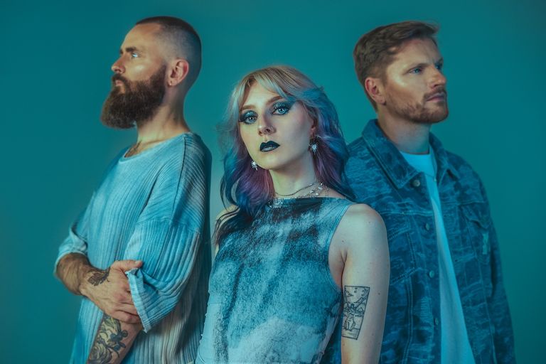 Post-hardcore band Future Palace posing under teal lighting, photo by Athina Paraschoudi.